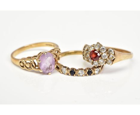 THREE 9CT GOLD GEM SET RINGS, the first designed with a central oval cut amethyst, openwork shoulders, with a 9ct hallmark fo