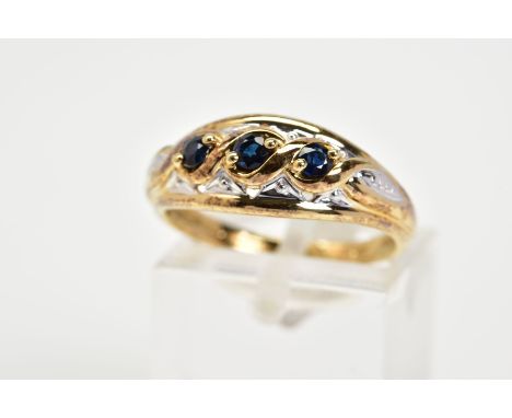 A 9CT GOLD SAPPHIRE RING, designed with three graduated circular cut sapphires, within a cross over mount, to an open work su