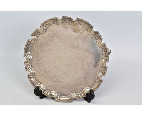 A GEORGE V SILVER SALVER, pie crust wavy rim, on three cabriole legs with scrolled feet, makers William Hutton &amp; Sons Ltd