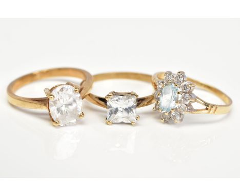 THREE 9CT GOLD GEM SET RINGS, the first a cluster design set with a central oval cut topaz within a circular cut cubic zircon