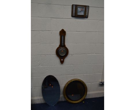 A REPRODUCTION MAHOGANY AND INLAID ANEROID BAROMETER, an oak barometer, a circular gilt wall mirror and another mirror (4)
