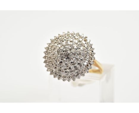 A 9CT GOLD DIAMOND CLUSTER RING, the tiered cluster ring set with single cut diamonds, to the tapered shoulders and plain pol