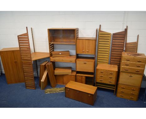 A STAPLES LADDERAX TEAK TEN BAY MODULAR SHELVING SYSTEM, comprising eleven tall wall mounted teak laddered uprights (one upri