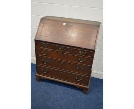 A GEORGIAN OAK AND BANDED BUREAU, with a fitted interior, six exterior drawers, on bracket feet, with brass swan neck handles
