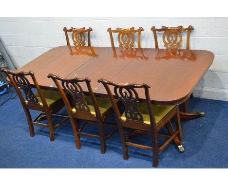 A REPRODUCTION GEORGIAN STYLE MAHOGANY TWIN PEDESTAL DINING TABLE, with rounded ends and one additional leaf, four legs to ea