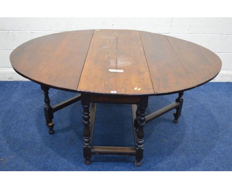 A GEORGIAN OAK OVAL TOPPED GATE LEG, table single frieze drawer, on turned and block legs united by stretchers, silvered pres