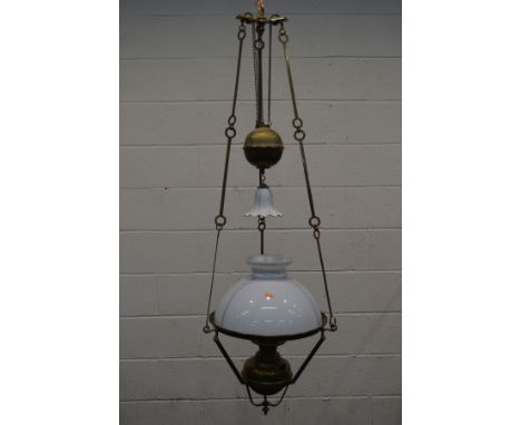 AN EARLY 20TH CENTURY BRASS RISE AND FALL CEILING OIL LAMP, with glass shades and funnel, diameter 43cm x minimum drop 132cm 