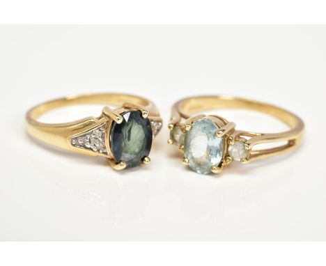 TWO 9CT GOLD GEM SET RINGS, the first designed with a claw set oval cut sapphire, to the single cut diamond details shoulders