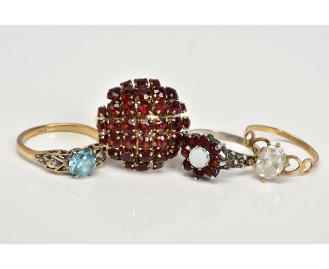 FOUR GEM SET RINGS, the first a yellow metal ring designed with a central circular cut topaz to the openwork shoulders, stamp