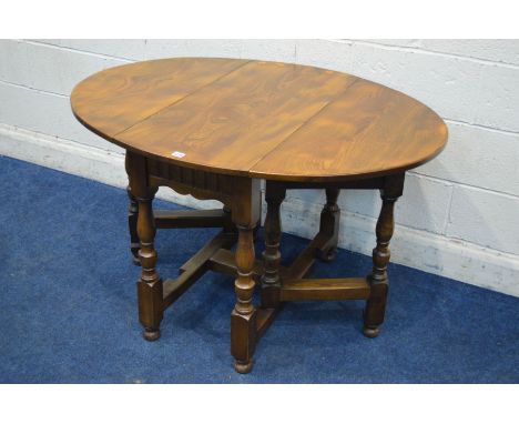 A REPRODUCTION ELM OVAL TOPPED GATE LEG TABLE, on turned and block legs united stretchers, open length 121cm x closed length 