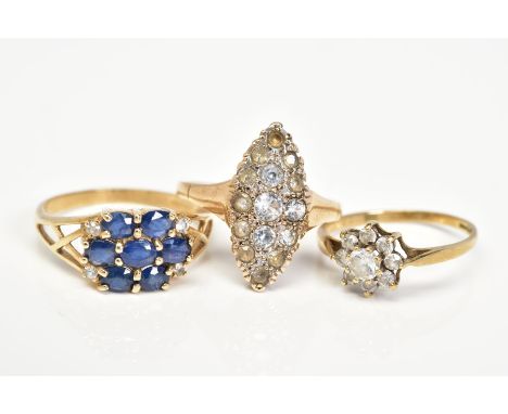 THREE 9CT GOLD RINGS, the first a cluster ring set with oval cut sapphires and colourless topaz, openwork shoulders, with a 9