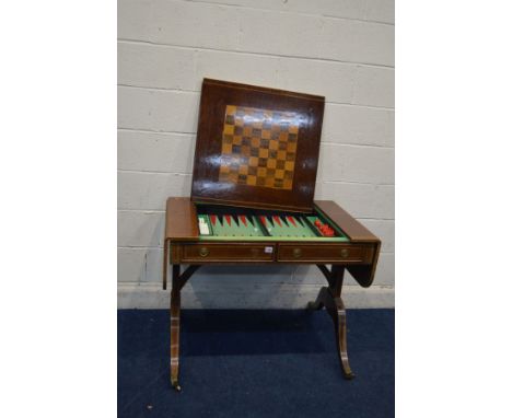 A REPRODUCTION SOFA TABLE GAMES COMPENDIUM with a removable back gammon baize, two dice, fourteen red and fourteen white coun