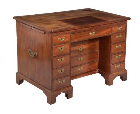  A George III mahogany kneehole desk  , circa 1760, the cleated rectangular top hinged to be raised on a ratchet adjustable r