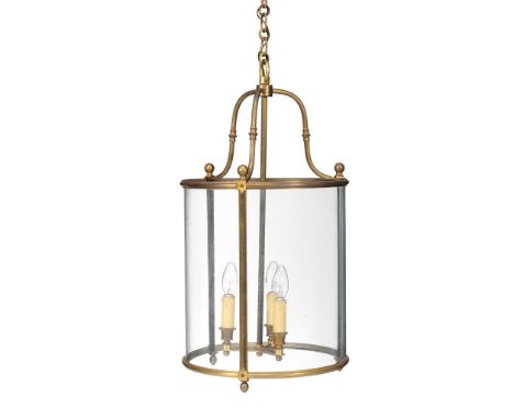  A gilt metal and glazed cylindrical hall lantern,   early 20th century, with three bowed glass panes beneath three serpentin