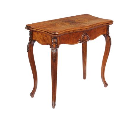  A Victorian walnut card table in French taste  , circa 1860, the bookmatched veneered top with moulded edge opening to a bai