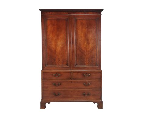  A mahogany linen press  , early 19th century, the panel doors enclosing later hanging rails, 205cm high, 130cm wide, 61cm de