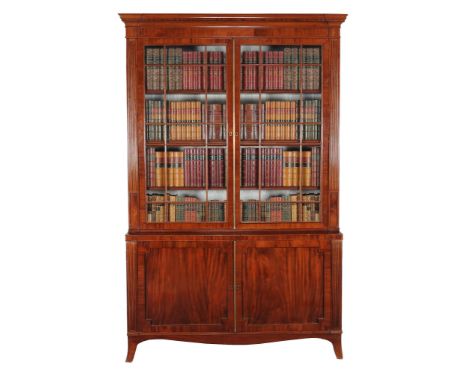  A Regency mahogany bookcase,   circa 1815, the stepped moulded cornice above a pair of astragal glazed doors opening to adju