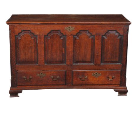  A George III oak mule chest,   circa 1770, with fluted angles flanking the moulded quadruple panel front and short drawers, 