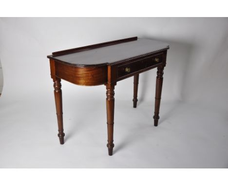 Victorian side table, mahogany with shaped top, four turned legs, centre drawer with pretty rosette brass handles, height 76 