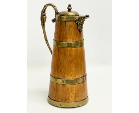 A large late 19th/early 20th century oak brass bound pitcher. Circa 1900. 18x29.5cm 