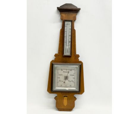 An early 20th century inlaid mahogany barometer. 21x58cm. 