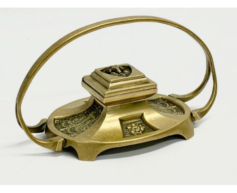 A Victorian brass inkwell. 20x10x12 