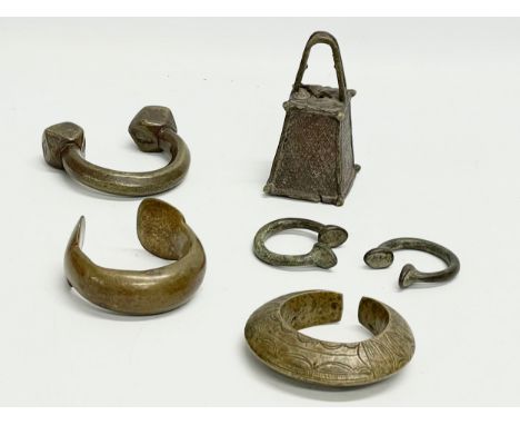 A collection of vintage African heavy brass bangle and bell. 