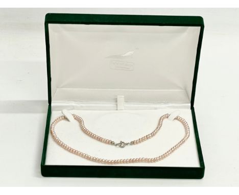 A vintage natural coloured pink pearl necklace with box. 