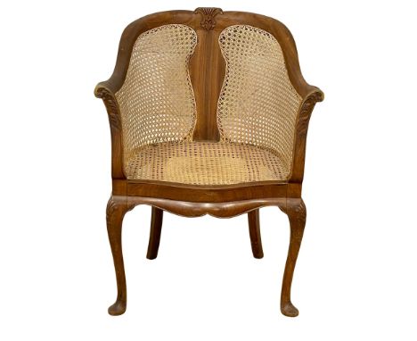 A vintage walnut tub chair with bergere back and seat on cabriole legs. 