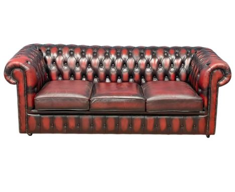 A deep button ox-blood leather 3 seater sofa. 198cm 