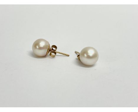 A pair of ladies 9ct gold and pearl earrings. 