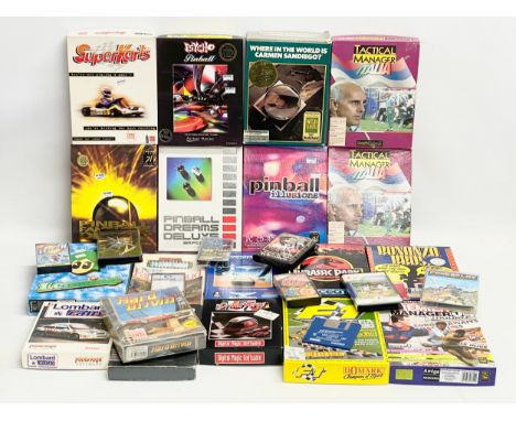 A collection of vintage computer games with boxes and paperwork. 