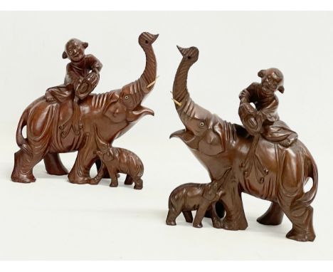 A pair of vintage Chinese Boxwood elephants with riders. 17x20cm 
