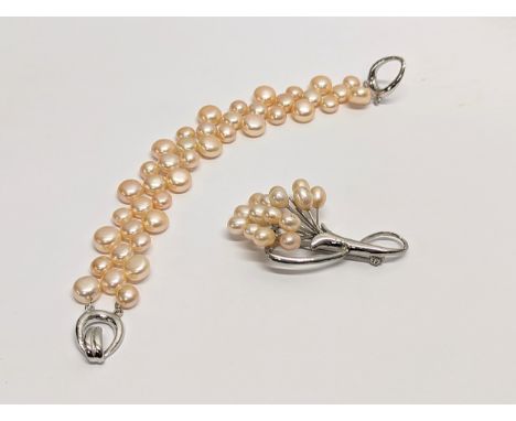 A pearl necklace and pearl brooch. Measurements of bracelet open 19cm 
