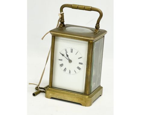 A good quality late 19th/early 20th century brass carriage clock with bevelled glass panels. With key. 8.5x7.5x13cm 
