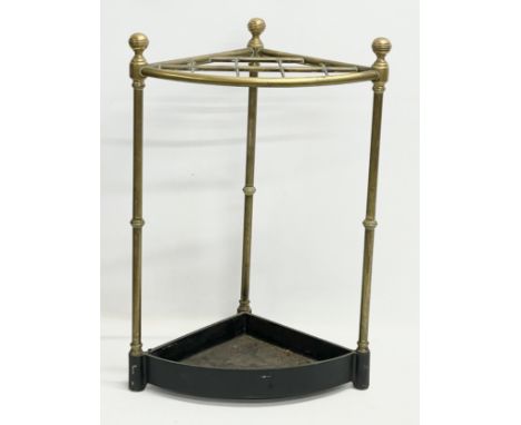 A late Victorian brass stick stand with cast iron base. 42x29x63cm 