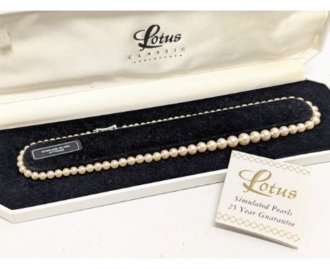 A simulated pearl necklace with silver fittings. 