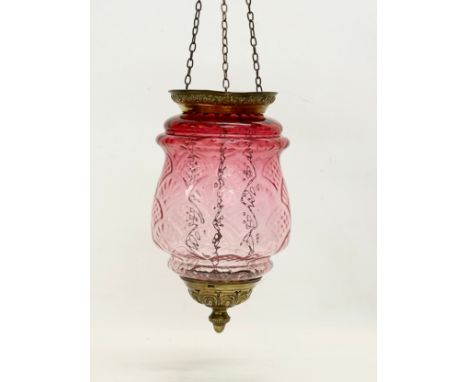 An early 20th century brass and Ruby Glass light shade. Circa 1900. Shade measures 21x34cm. 62cm including chain. 