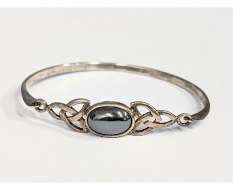 A silver bracelet / bangle. 