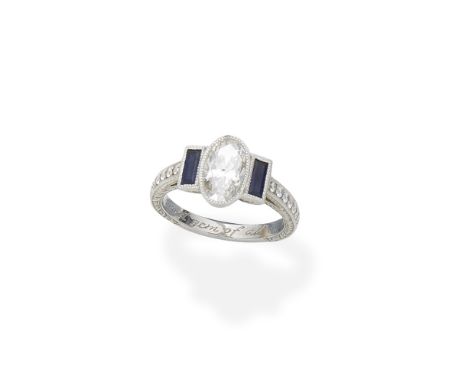 Diamond and sapphire ringThe oval-cut diamond between step-cut sapphires, the band with brilliant-cut diamonds and engraved d