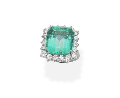 Emerald ring and diamond cluster ringThe octagonal step-cut emerald, weighing 15.00 carats, within a brilliant-cut diamond su