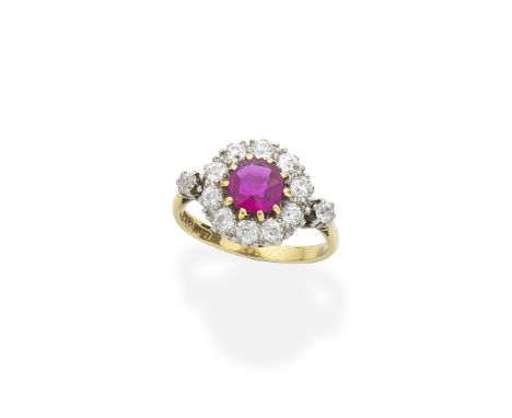 Ruby and diamond cluster ringThe circular-cut ruby and old brilliant-cut diamond cluster between similarly-cut diamond should