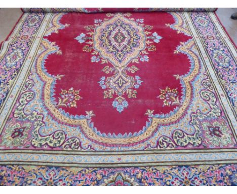 A Large 20th Century Persian Wool Carpet, ruby and pale blue, pink and purple ground of foliate design, approx 304 x 420 cms,