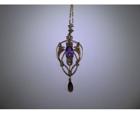 An Art Nouveau 9ct Yellow Gold Amethyst and Seed Pearl Pendant. The pendant suspended from a 9ct gold chain, 1 x 8.5 x 6.5 an
