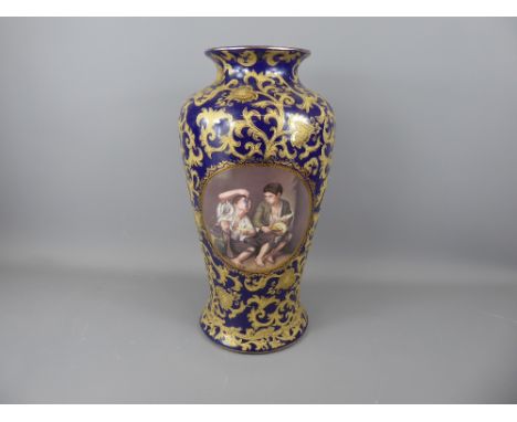 A Continental Porcelain Blue and Gilt Effect Portrait Vase depicting beggar boys eating grapes and melons, after the Spanish 