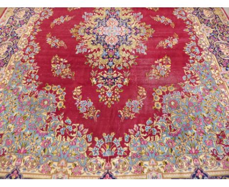 A Large 20th Century Persian Wool Carpet,  ruby, pale blue and green ground of foliate design, approx 412 x 304 cms, some min