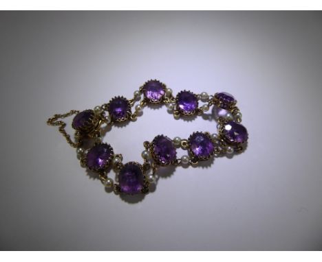 A Vintage 9ct Gold Amethyst and Pearl Bracelet, set with ten oval amethyst with pearl links, approx 16 cms, approx 13.9 gms, 
