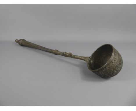 An Antique Pewter Ladle, incised with foliate decoration, possibly Ottoman, approx 55 cms.