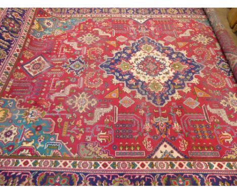 A Large 20th Century Persian Wool Carpet, ruby, jewel green, turquoise and cream ground of foliate design, approx 393 x 280 c