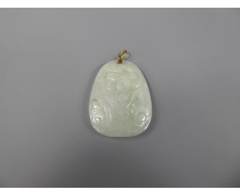 A White Jade Amulet Pendant on a 14ct yellow gold (tested) mount, carved with a fish and serpent, approx 50 x 37 mm.